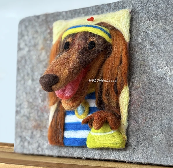 Felt portrait of a dachshund wearing a striped shirt