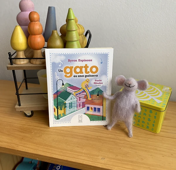 Illustrated book on a table next to a felt figure